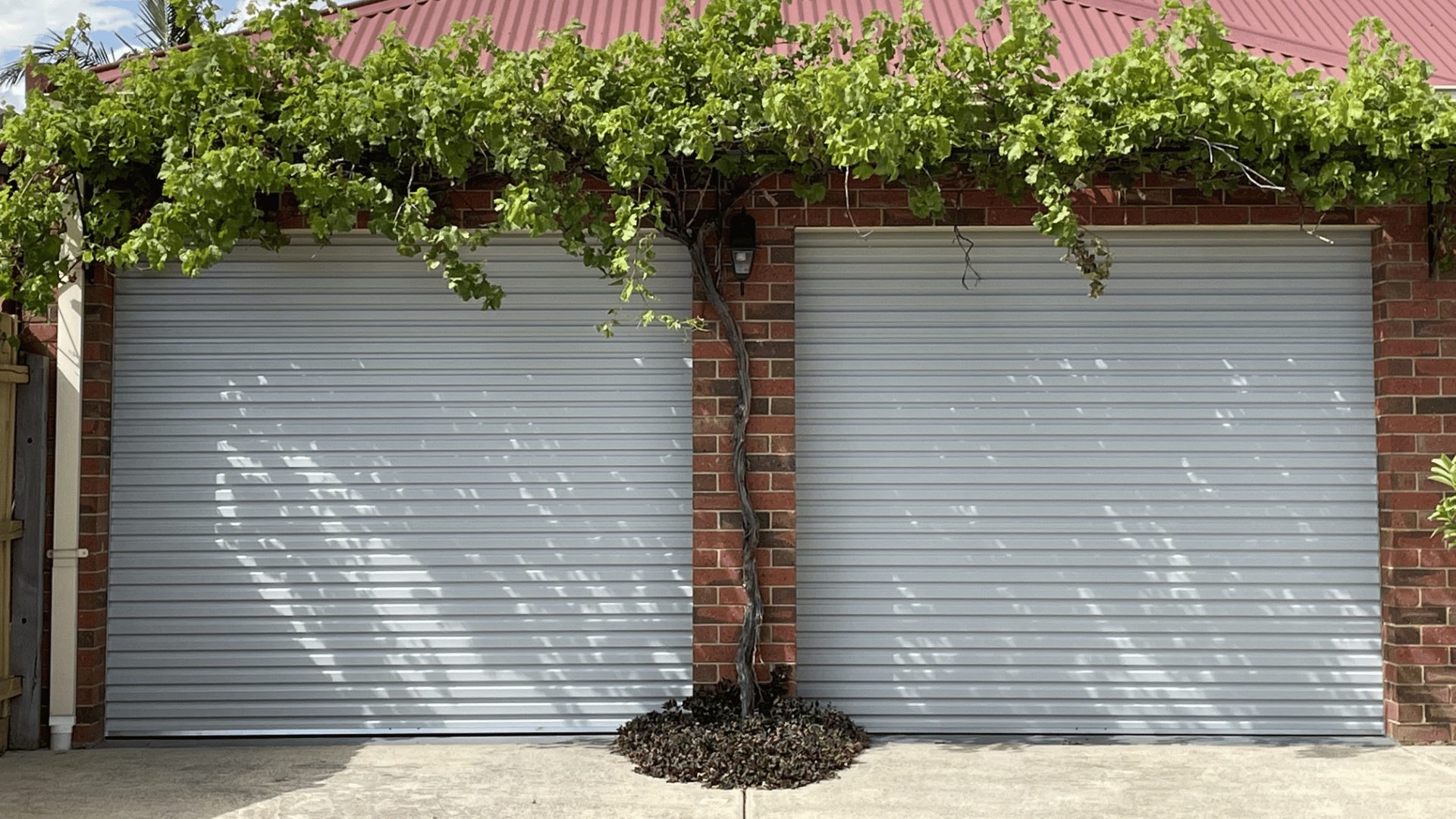 White roller doors on a brick house